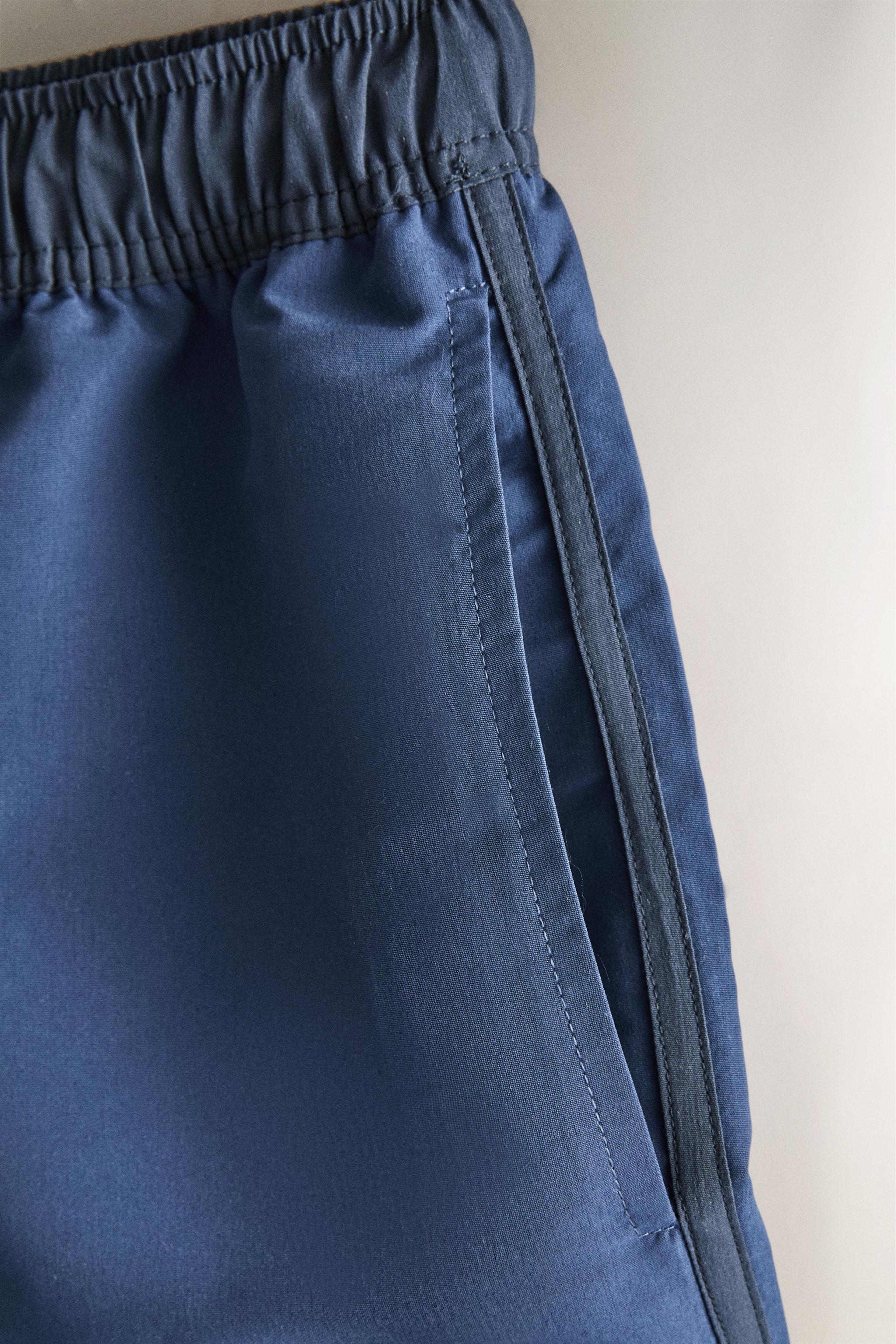 SHORT DE BAIN UNI À CONTRASTE